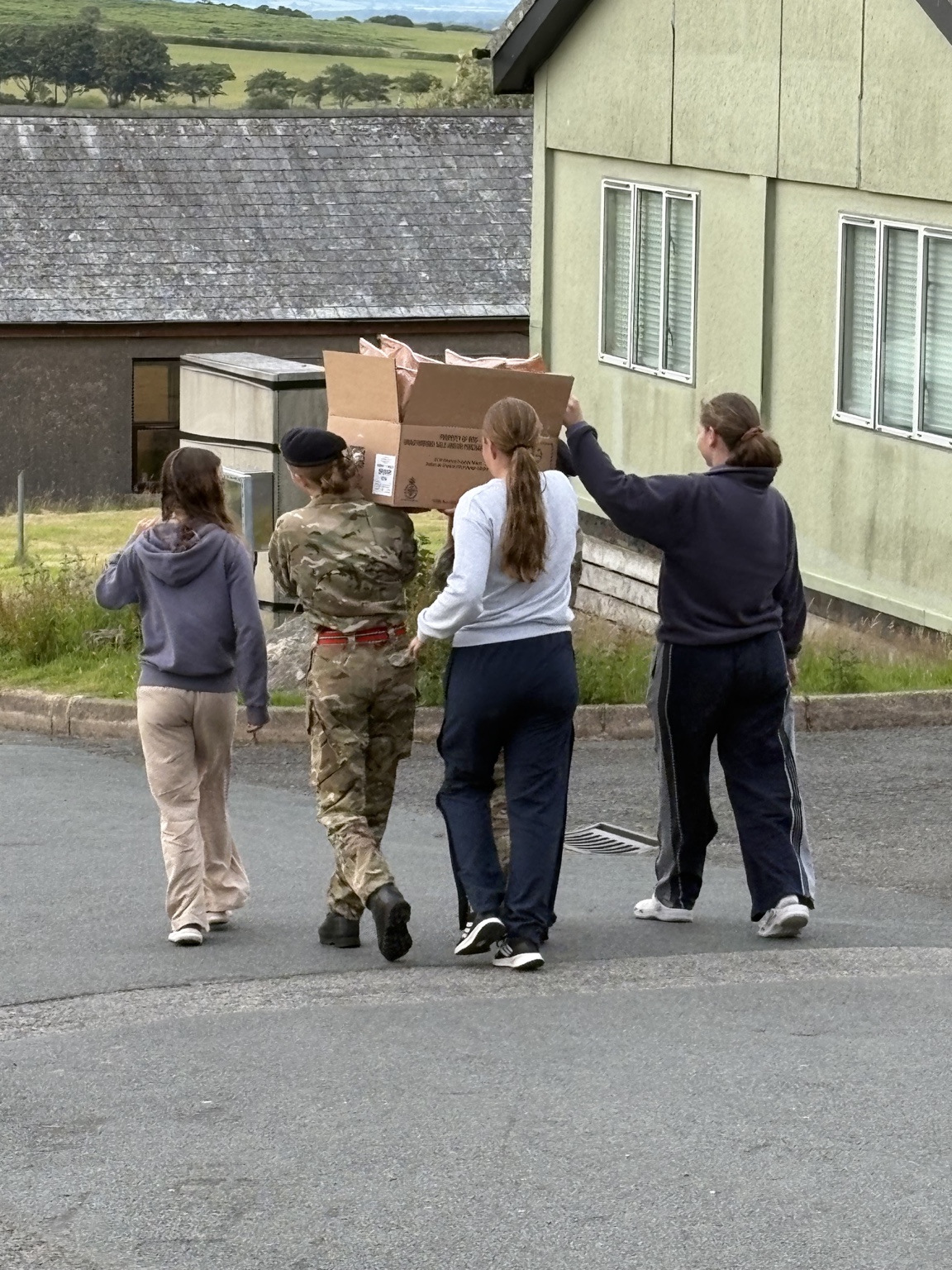 Cadets carrying equipment together