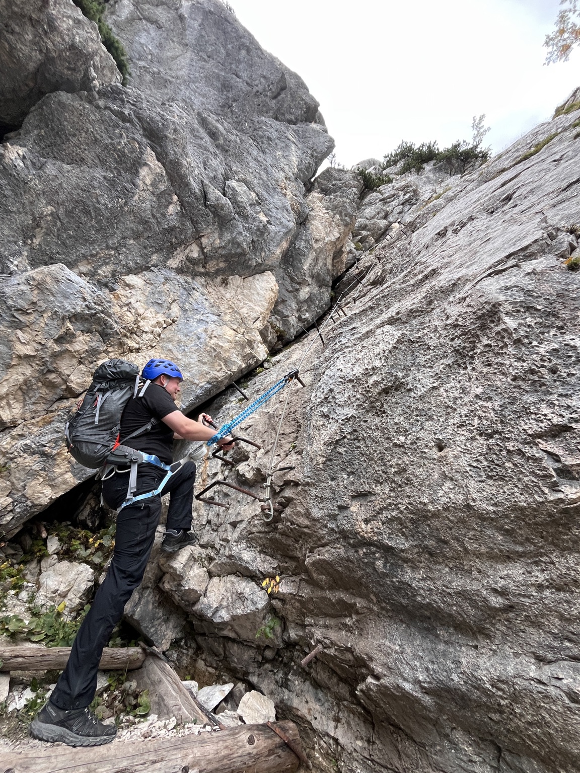 A climber moving along a protected via ferrata route