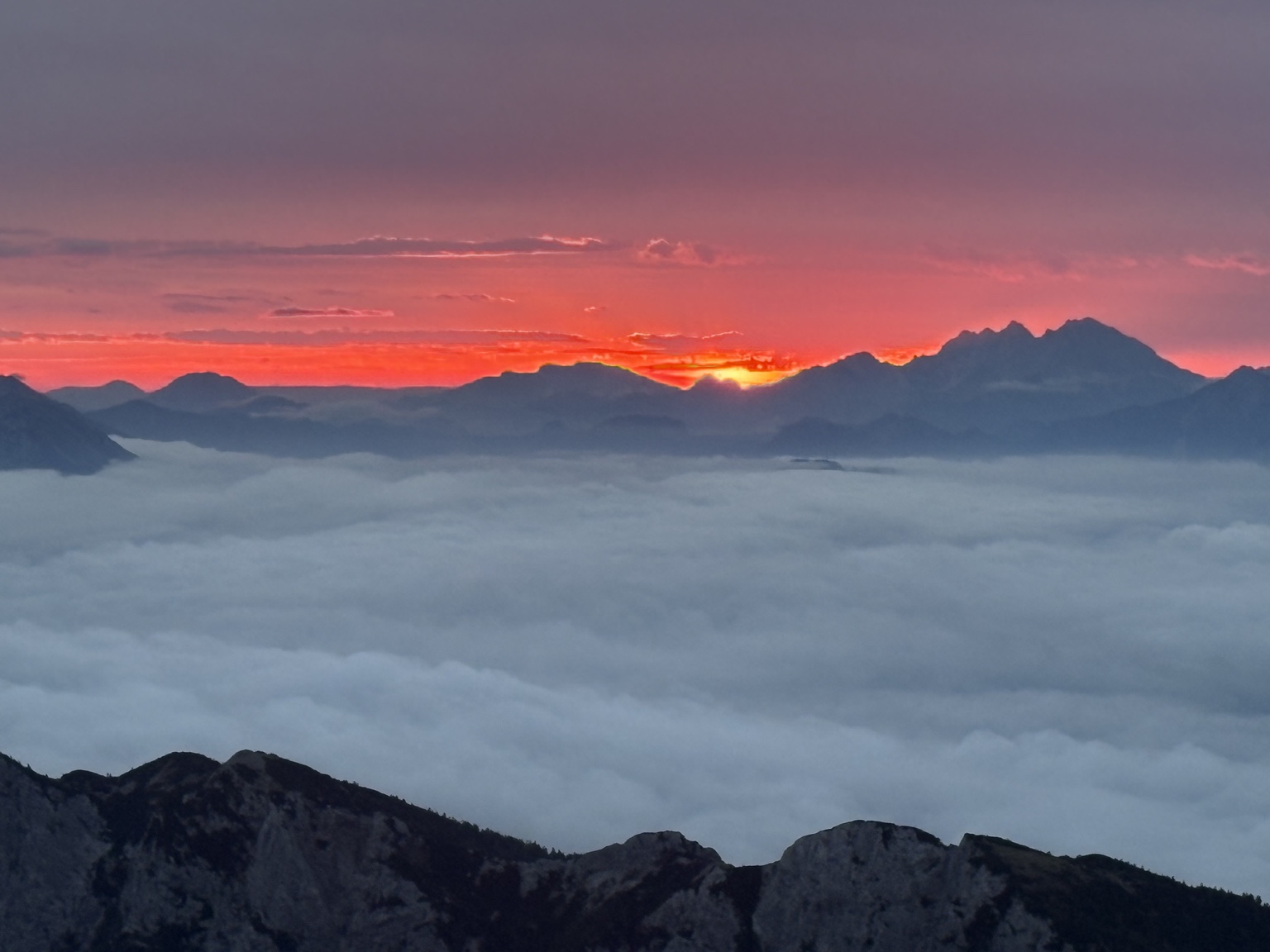 Sunrise above the cloud line in the mountains