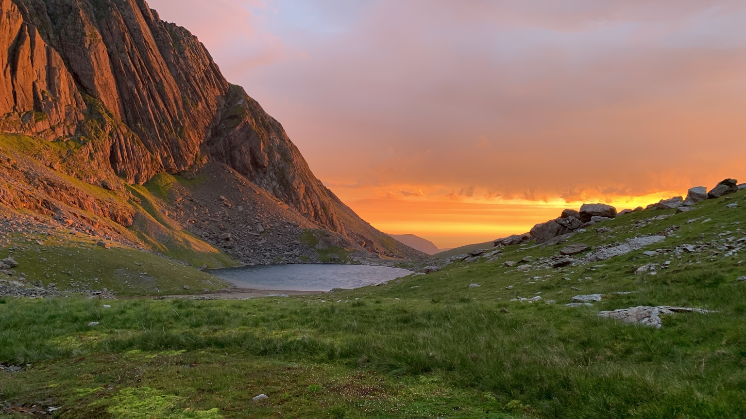 A mountain lake beneath a golden evening sky